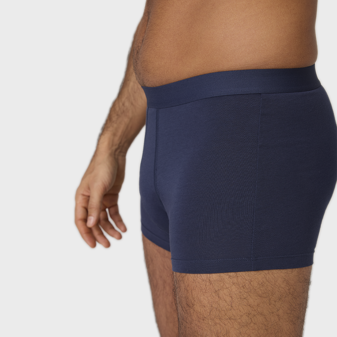 Man wearing NEW TENA Men Protective Boxers Light, showcasing comfortable fit and built-in protection.
