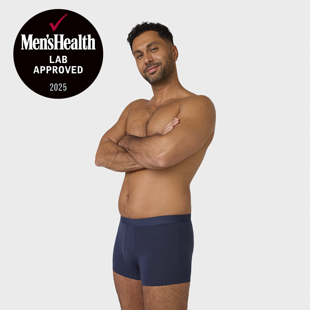 Man confidently models NEW TENA Men Protective Boxers, featuring a sleek design and Men’s Health LAB APPROVED 2025 seal for incontinence protection.