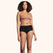 Woman modeling Soft Cotton Classic Washable Underwear for Light Incontinence, showcasing high-cut design and waistband, emphasizing comfort and protection against light urine leaks.