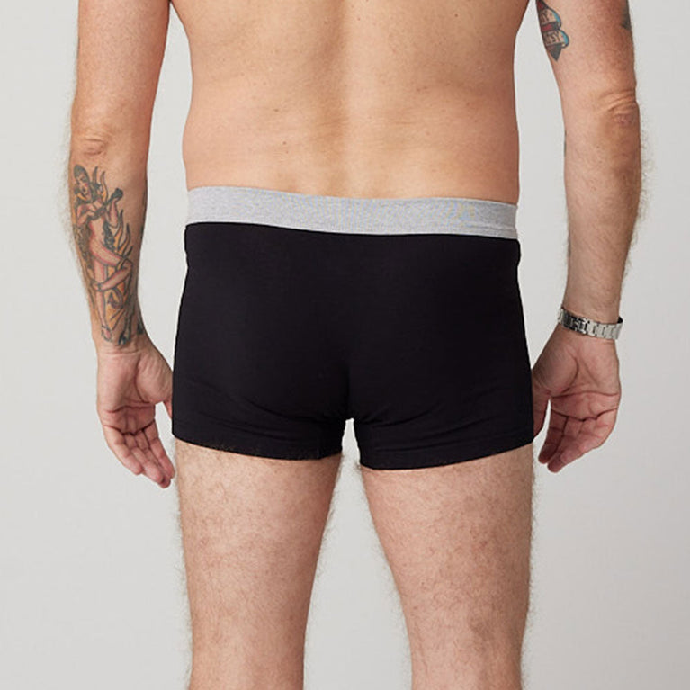 Man wearing TENA Men Protective Boxers Light, showcasing the comfortable fit and design for light incontinence protection.
