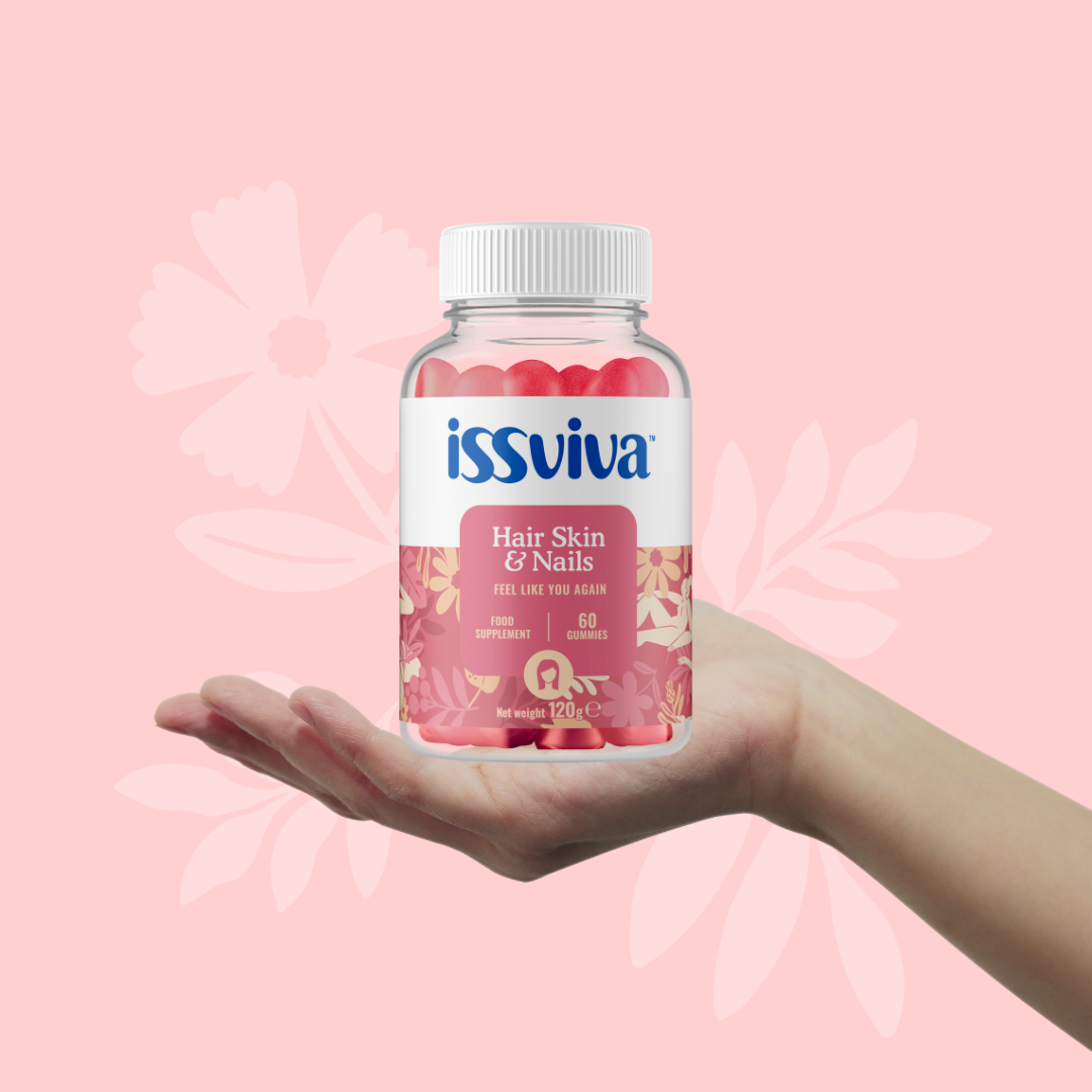 Hand holding Issviva “Hair Skin & Nails” gummies jar from the Stylish Beauty Bumper Bundle, featuring a pink floral label and 60 red/pink gummies for hair, skin, nails health.