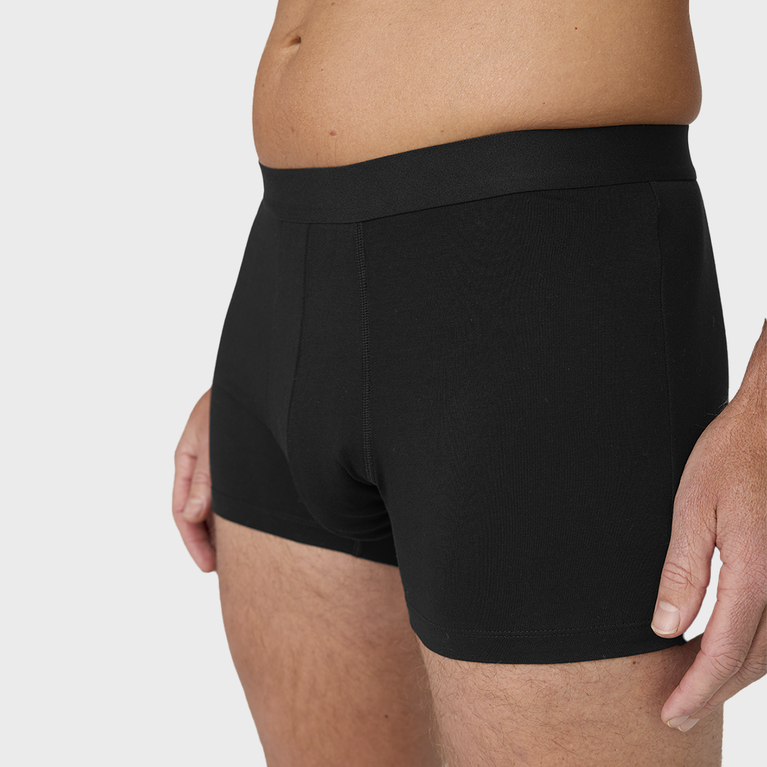 Man wearing NEW TENA Men Protective Boxers Light, showcasing their snug fit and comfort, designed for everyday wear with built-in incontinence protection.