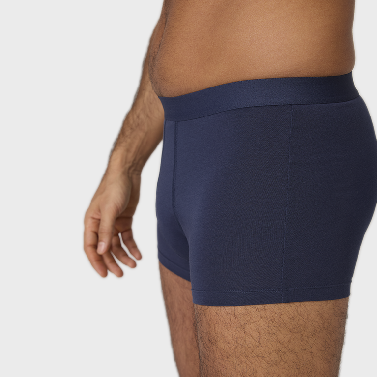 Man wearing NEW TENA Men Protective Boxers Light, showcasing comfortable fit and built-in protection.
