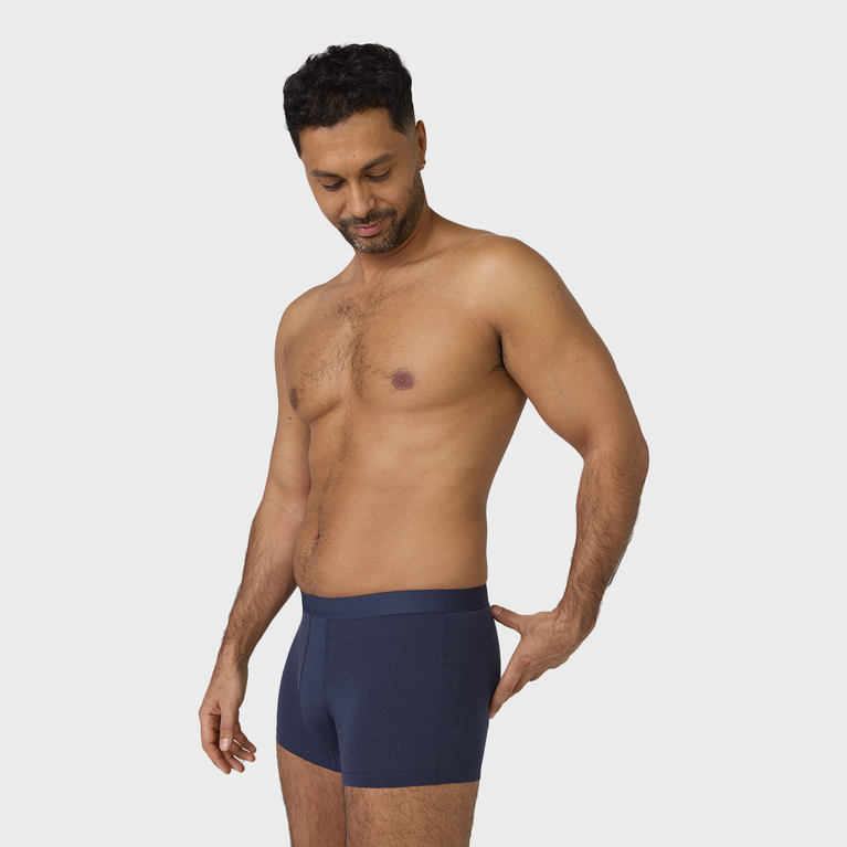 Man wearing NEW TENA Men Protective Boxers Light, showcasing the washable, soft organic cotton incontinence underwear with built-in protection, resembling regular boxer briefs.