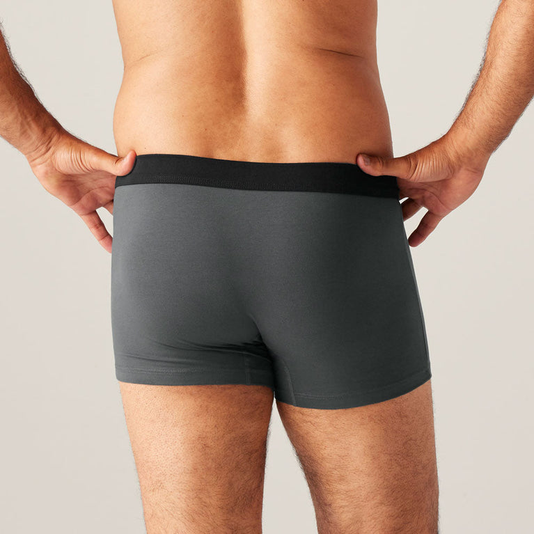 TENA Men Protective Boxers Light, featuring a man wearing grey boxer briefs designed for light incontinence with built-in protection, offering a discreet and comfortable fit.