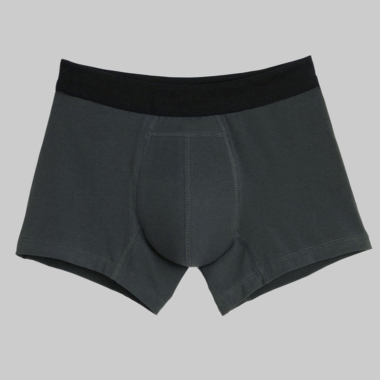 TENA Men Protective Boxers Light, featuring a close-up of black and grey boxer briefs designed for discreet incontinence protection with ergonomic Secure Absorption Zone.