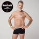 Middle-aged man models TENA Men Protective Boxers, showcasing tattoos and black boxer briefs with Men’s Health Lab Approved 2025 badge in the corner.