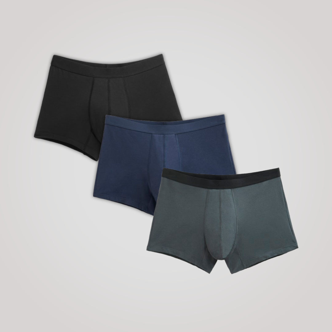 TENA Men 3 Pack Protective Boxers featuring soft organic cotton and four-layer protection, includes three pairs in exclusive colors, laid side by side.