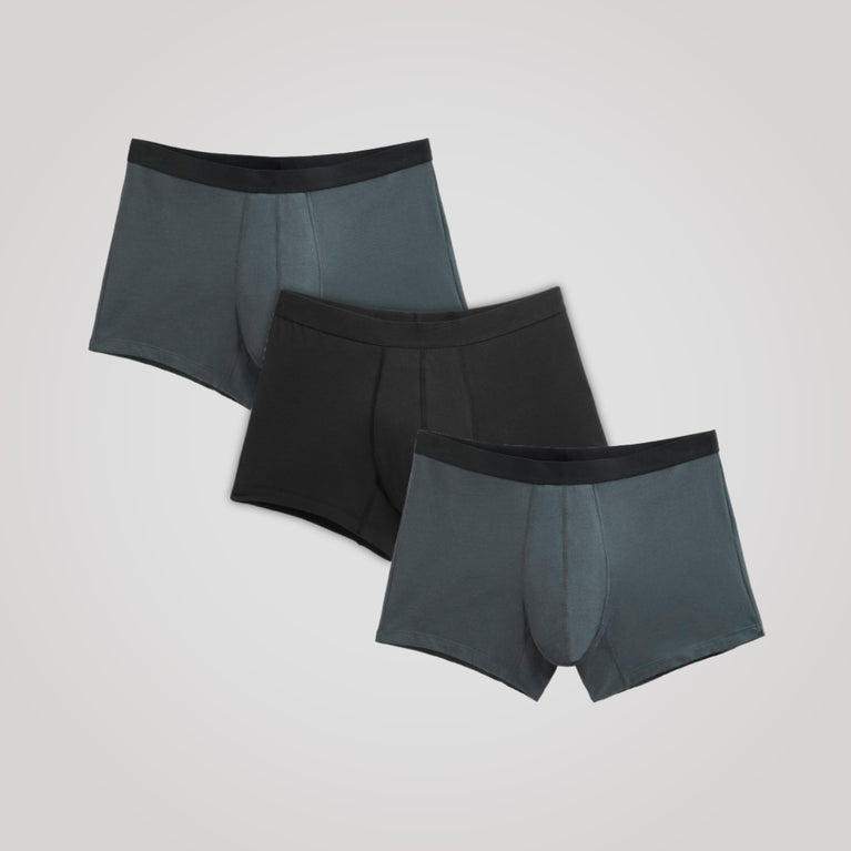 TENA Men 3 Pack Protective Boxers showing two slate-gray and one black pair, offering soft organic cotton comfort with four-layer protection against drips.