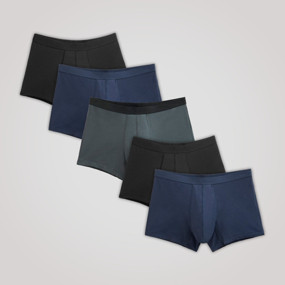 TENA Men 5 Pack Protective Boxers displayed in a staggered layout. Includes five pairs offering discreet incontinence protection with soft organic cotton and multilayer absorption.