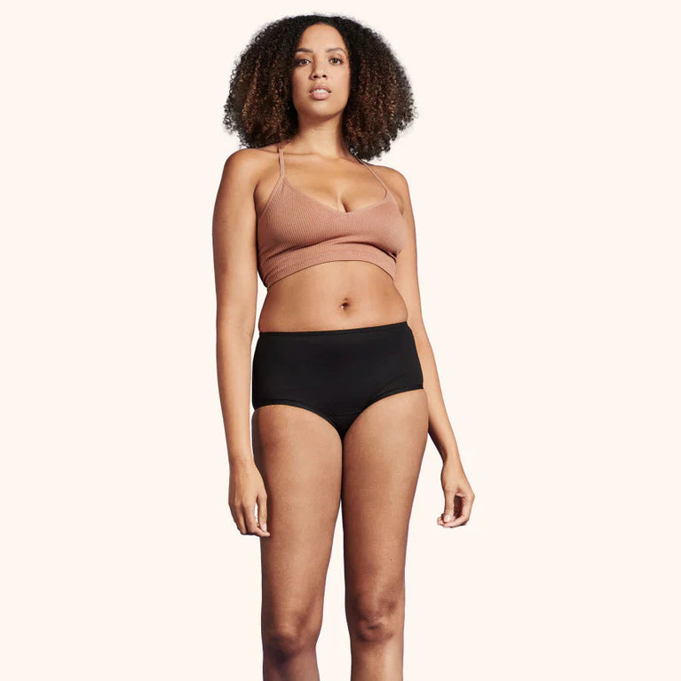 TENA Washable Soft Cotton Underwear | 3-Pack features a woman modeling high-cut, breathable cotton incontinence pants designed for comfort and light leak protection.