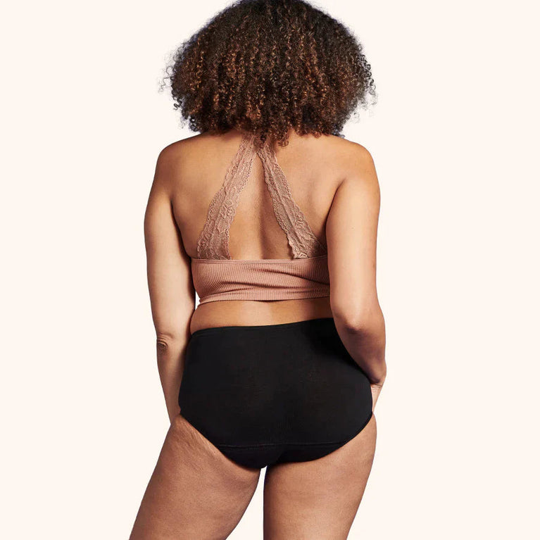 TENA Washable Soft Cotton Underwear | 3-Pack, featuring a woman modeling the high-cut, breathable incontinence pants with a comfortable waistband and soft cotton material.